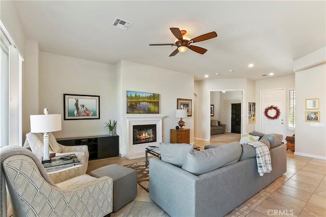 tiled living room featuring ceiling fan