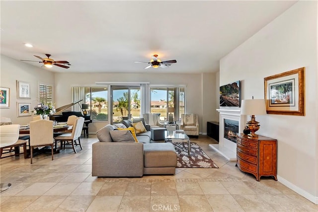 tiled living room featuring ceiling fan