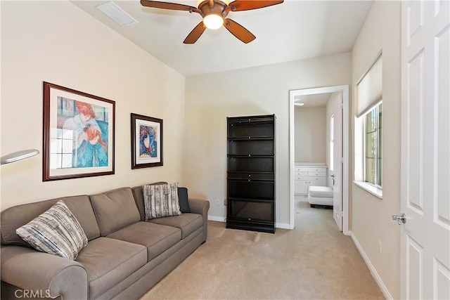 carpeted living room featuring ceiling fan