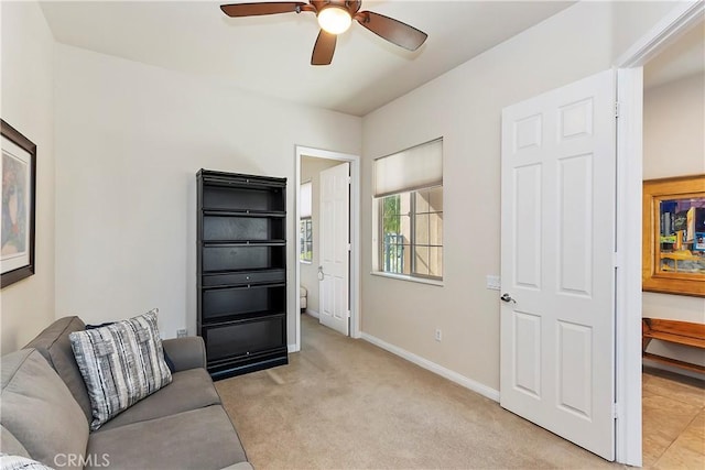 living room with light carpet and ceiling fan