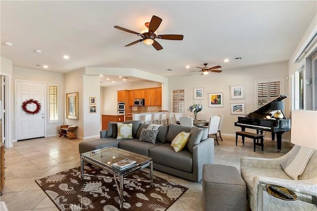 tiled living room featuring ceiling fan