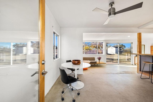 interior space with ceiling fan and concrete flooring