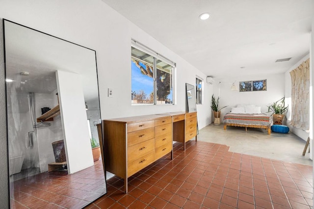 interior space with a wall mounted air conditioner and tile patterned floors