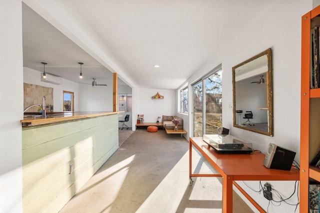 interior space featuring ceiling fan and sink