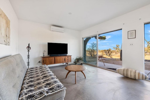 living room featuring an AC wall unit and concrete floors