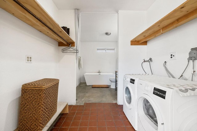 clothes washing area featuring washer and dryer