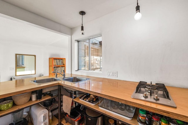 interior space featuring pendant lighting, stainless steel gas cooktop, and sink