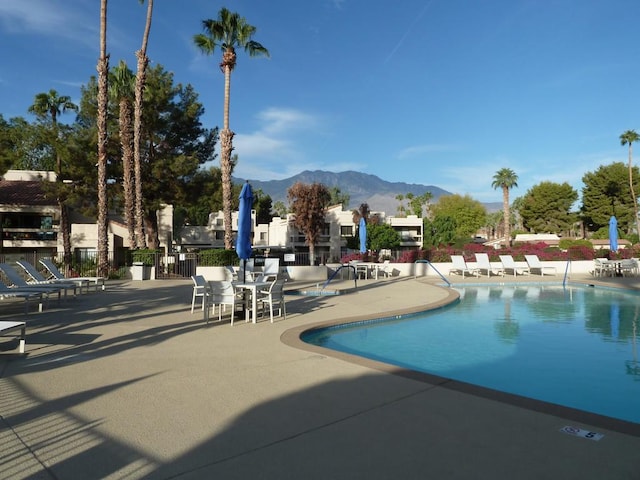 view of swimming pool featuring a mountain view and a patio area