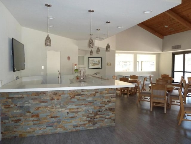 kitchen featuring beam ceiling, hanging light fixtures, wooden ceiling, dark hardwood / wood-style flooring, and high vaulted ceiling