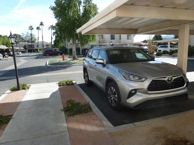 view of vehicle parking with a carport