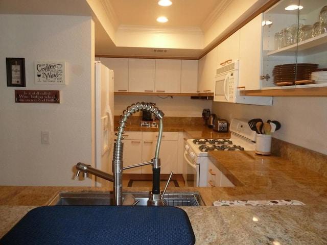 kitchen featuring white cabinets, sink, white appliances, and ornamental molding