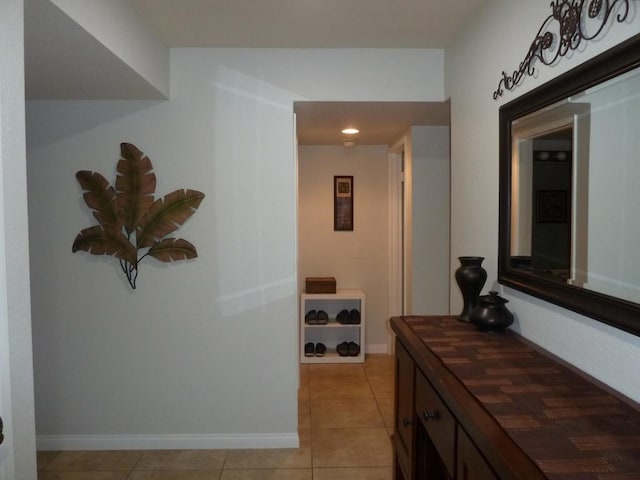 hall with light tile patterned floors