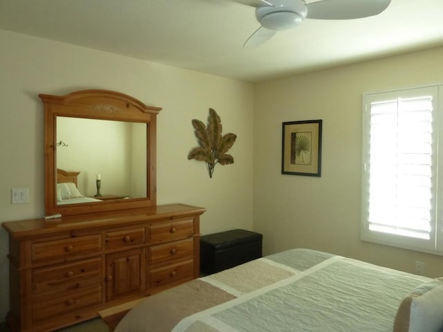 bedroom featuring multiple windows and ceiling fan