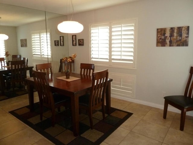 dining room featuring light tile patterned floors and a healthy amount of sunlight