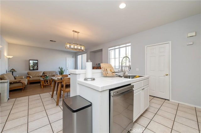 kitchen with white cabinets, sink, decorative light fixtures, a center island with sink, and dishwasher