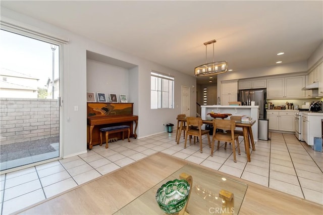 dining space featuring a chandelier and light tile patterned floors