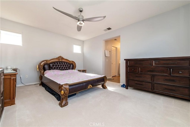 bedroom with ceiling fan and light colored carpet