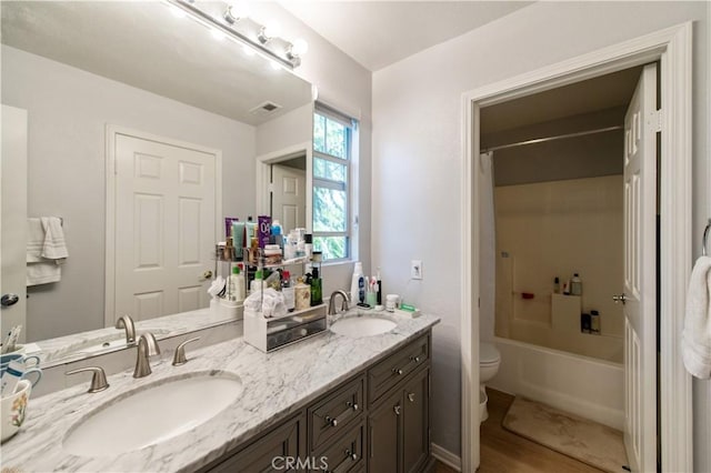 full bathroom with shower / bathing tub combination, vanity, toilet, and hardwood / wood-style flooring