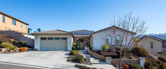 view of front of house featuring a garage and solar panels