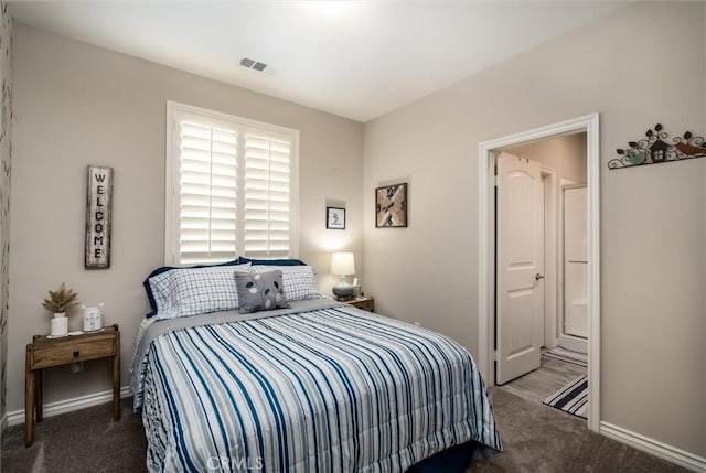 carpeted bedroom with connected bathroom