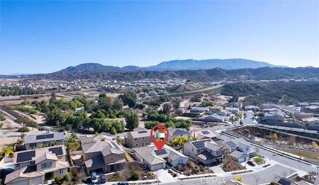 birds eye view of property with a mountain view