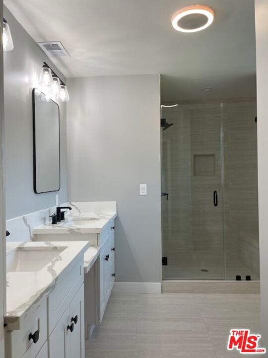 bathroom with walk in shower and vanity