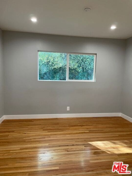 spare room with light wood-type flooring