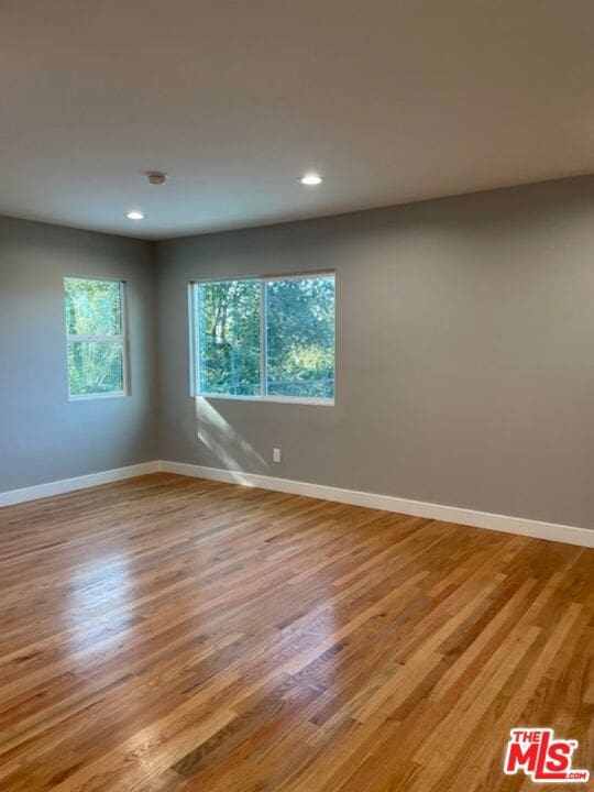 unfurnished room featuring light hardwood / wood-style floors