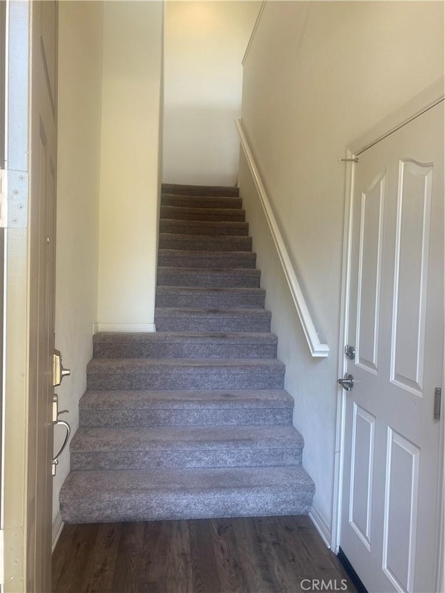 stairs featuring wood finished floors