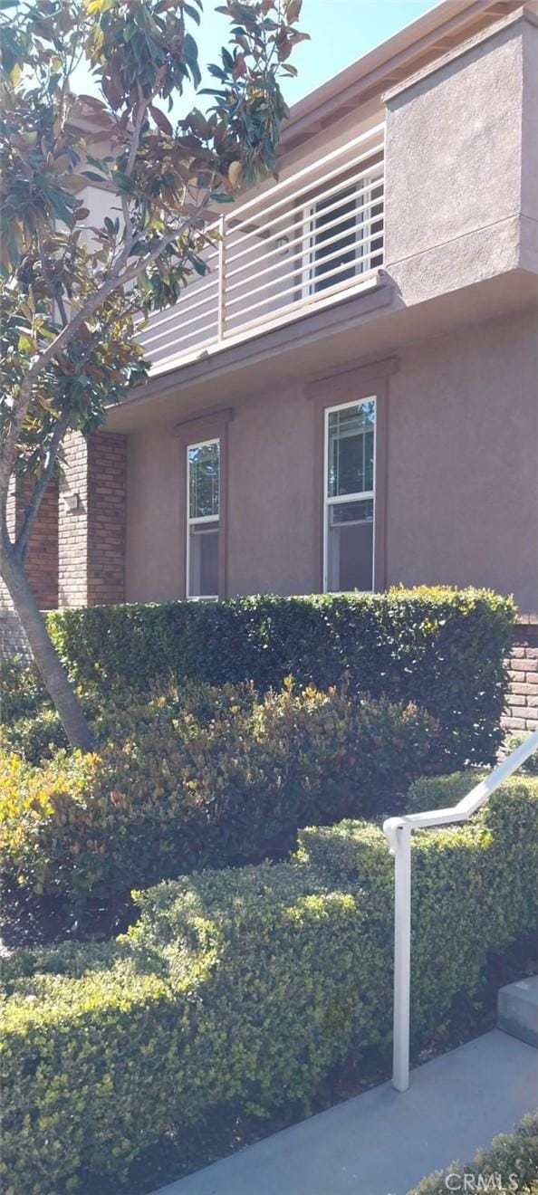 view of home's exterior with a balcony and stucco siding