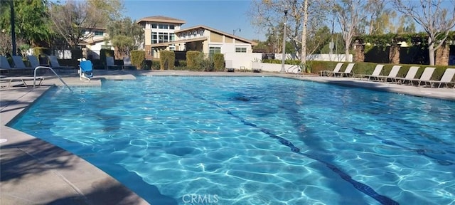 pool featuring a patio area and fence