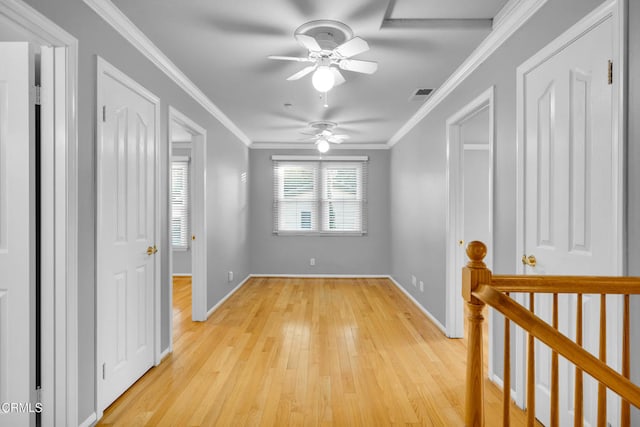 spare room featuring light hardwood / wood-style flooring, ceiling fan, and crown molding