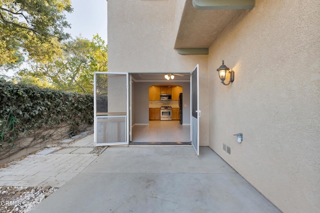 entrance to property with a patio area