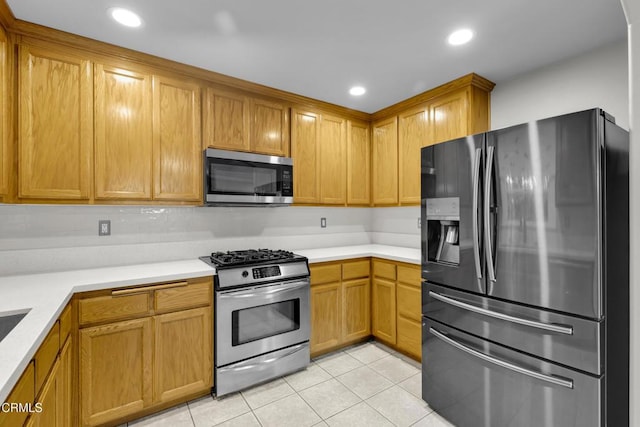 kitchen featuring light tile patterned floors and appliances with stainless steel finishes