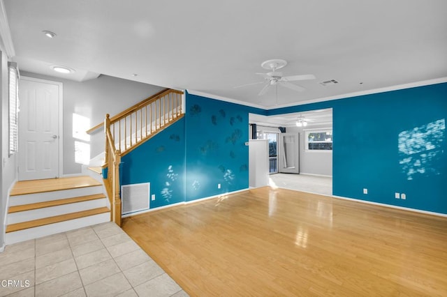 unfurnished living room with light hardwood / wood-style floors, ceiling fan, and ornamental molding