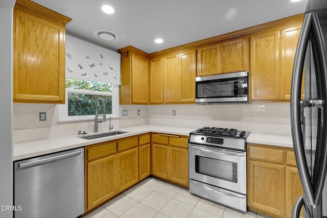 kitchen featuring light tile patterned floors, sink, and appliances with stainless steel finishes