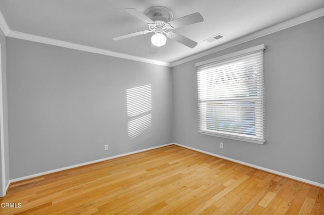 empty room featuring ceiling fan, light hardwood / wood-style floors, and crown molding