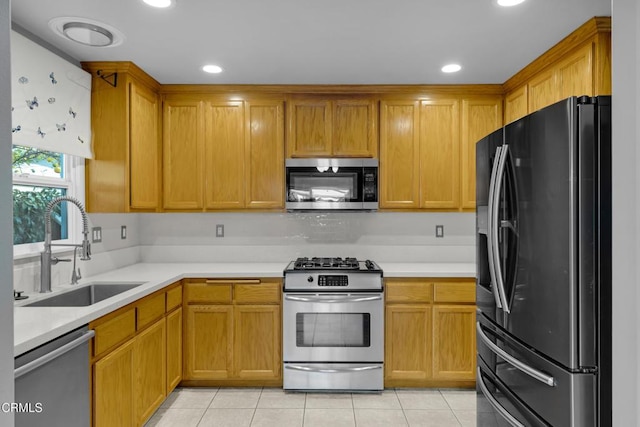 kitchen featuring sink, light tile patterned floors, and stainless steel appliances