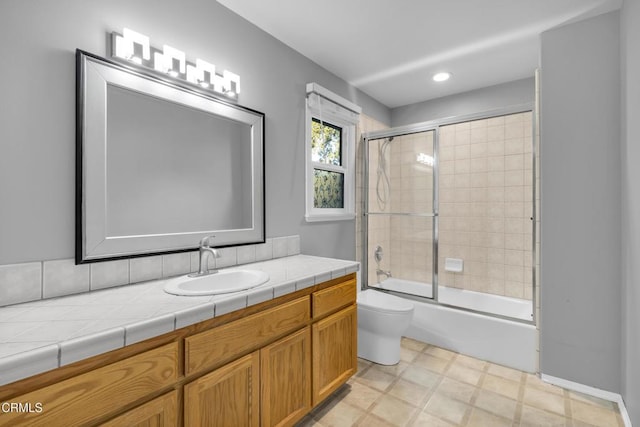 full bathroom with vanity, enclosed tub / shower combo, and toilet