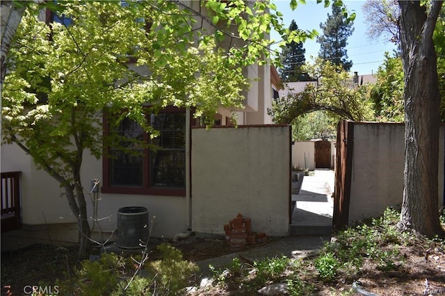 view of side of home with central AC unit