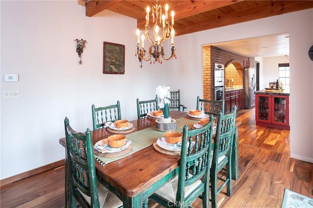 dining area with wood ceiling, beamed ceiling, wood-type flooring, and an inviting chandelier