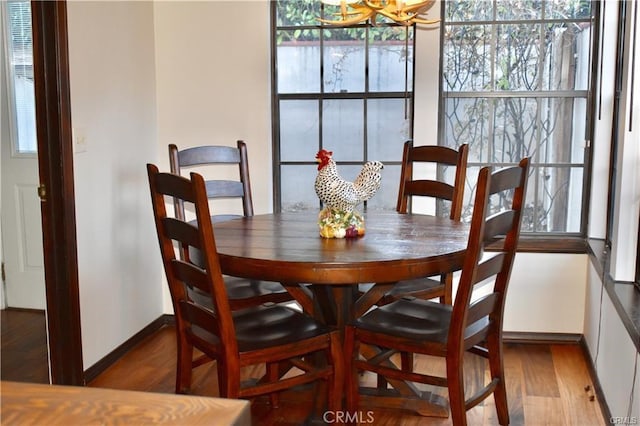 dining room featuring hardwood / wood-style flooring and a notable chandelier