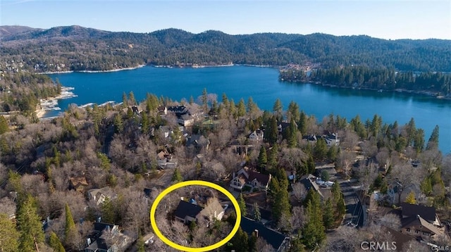 drone / aerial view featuring a water and mountain view