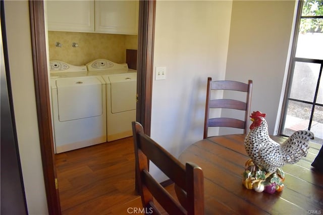 dining room with hardwood / wood-style flooring and independent washer and dryer