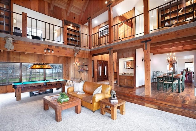 game room with beamed ceiling, high vaulted ceiling, pool table, and wood walls