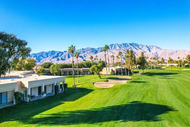 view of property's community with a lawn and a mountain view