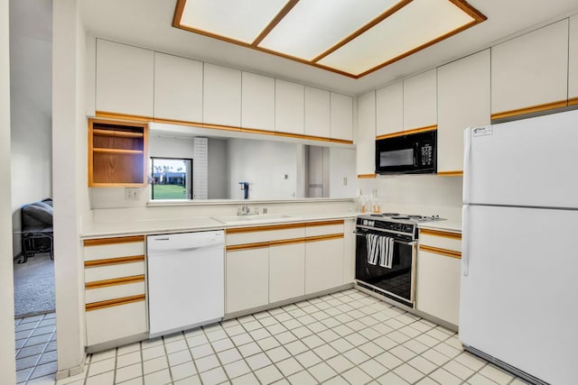 kitchen featuring kitchen peninsula, white appliances, white cabinetry, and sink