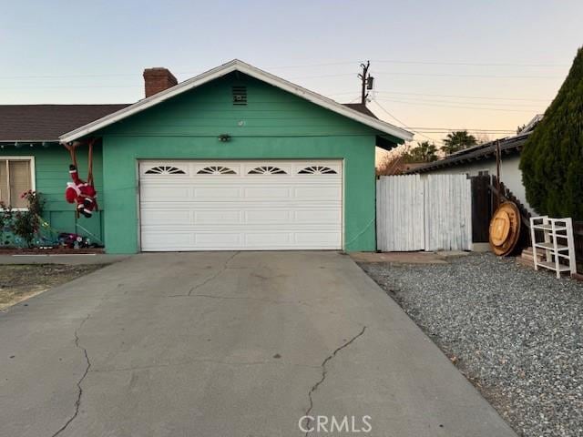 view of garage at dusk