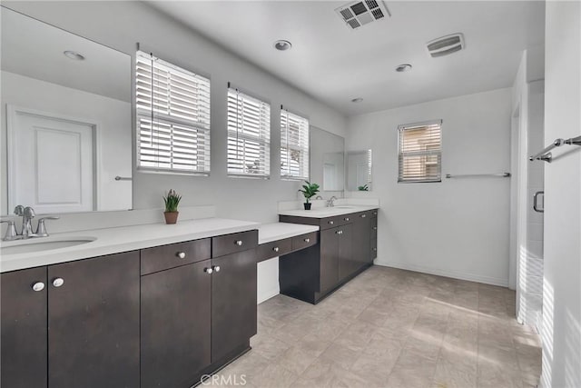 bathroom with vanity and a shower with shower door