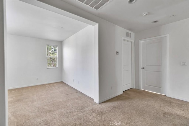 unfurnished room with light colored carpet